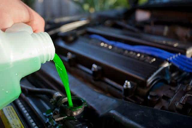 pouring coolant in engine