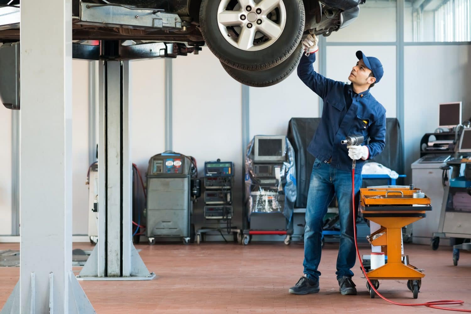 mechanic inspecting car tires
