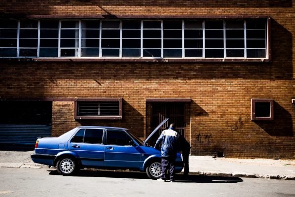 two people fixing car